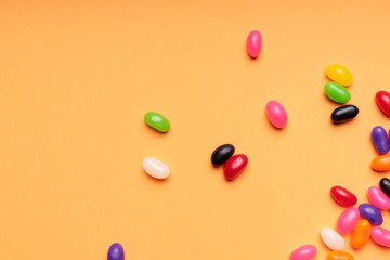 colourful jelly beans candies orange background Top view