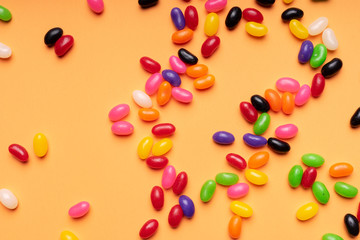 colourful jelly beans candies orange background Top view