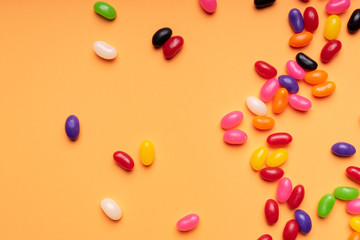 colourful jelly beans candies orange background Top view
