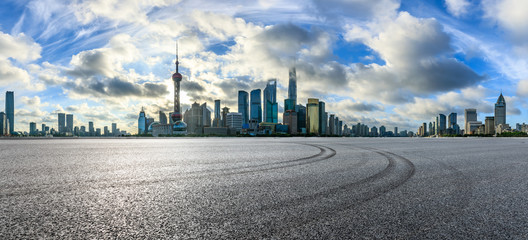 Empty race track and modern city scenery at sunrise in Shanghai,China.