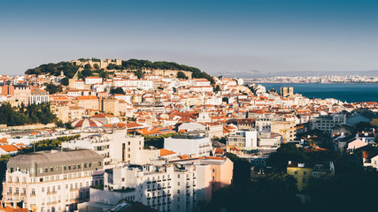 Panoramic view over the center of Lisbon from the viewpoint called: Miradouro de Sao Pedro de Alcantara featuring the Baixa neighbourhood and Castelo Sao Jorge