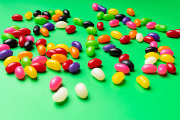 colourful jelly beans candies green background Top view