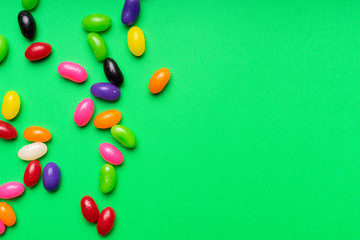 colourful jelly beans candies green background Top view