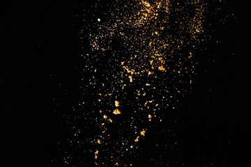 Fototapeta na wymiar Powder particles on black background