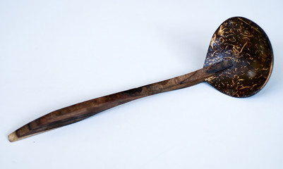 Coconut shell ladle from Indonesia on white background.