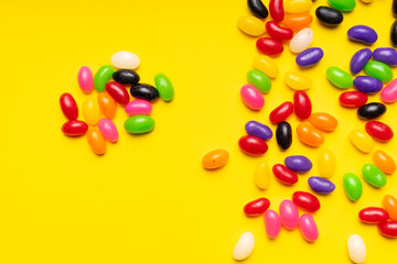 colourful jelly beans candies yellow background Top view 