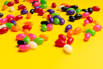Obraz premium colourful jelly beans candies yellow background Top view 