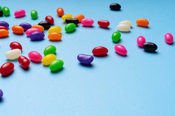 colourful jelly beans candies blue background Top view