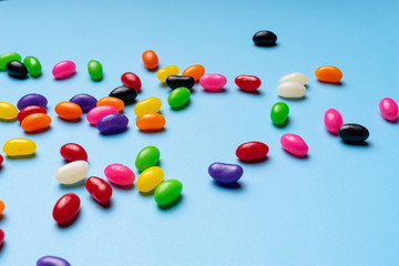 colourful jelly beans candies blue background Top view