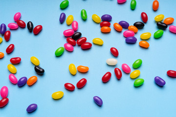 colourful jelly beans candies blue background Top view