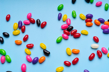 colourful jelly beans candies blue background Top view