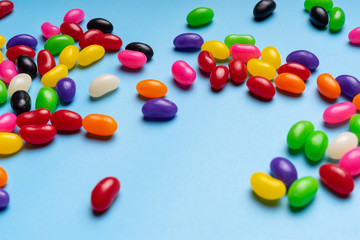 colourful jelly beans candies blue background Top view