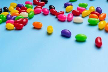 colourful jelly beans candies blue background Top view