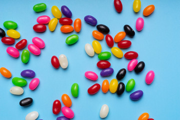 colourful jelly beans candies blue background Top view