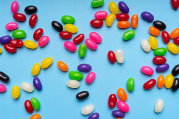 colourful jelly beans candies blue background Top view
