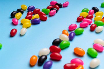 colourful jelly beans candies blue background Top view