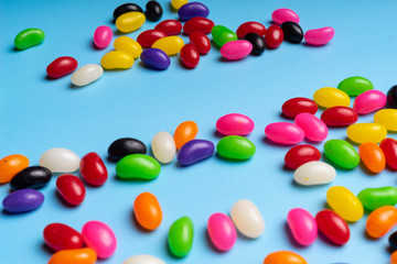 colourful jelly beans candies blue background Top view