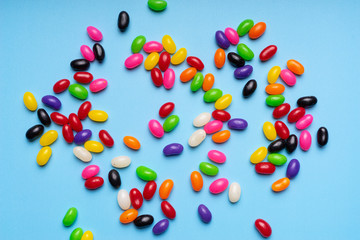 colourful jelly beans candies blue background Top view