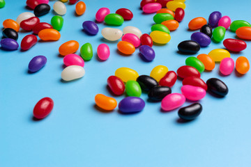 colourful jelly beans candies blue background Top view