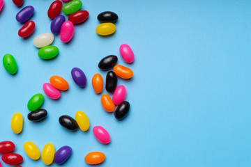 colourful jelly beans candies blue background Top view