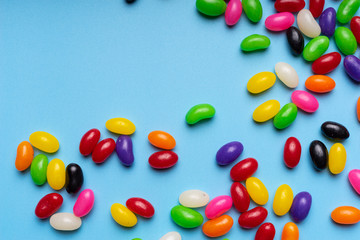 colourful jelly beans candies blue background Top view