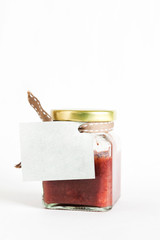Paper tag on strawberry amaretto jam bottle