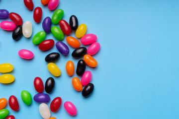 colourful jelly beans candies blue background Top view