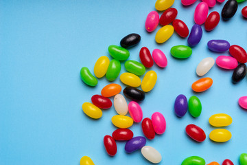 colourful jelly beans candies blue background Top view