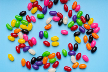 colourful jelly beans candies blue background Top view