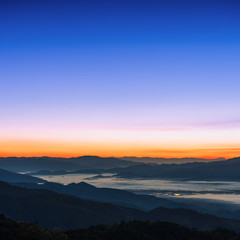 Fototapeta na wymiar Beautiful foggy winter sunrise in mountains background.