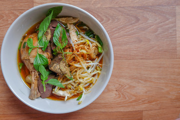 Thai noodle soup with chicken and vegetables.	