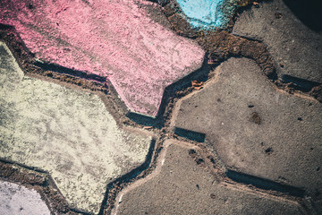 The paved stone walkway with colored crayons painted by children.