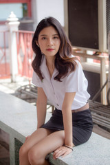 Portrait of thai adult student university uniform beautiful girl relax and smile