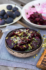Sweet beetroot salad. Cooked with olive oil, vinegar, pumpkin and sesame seeds , herbs in bowl. Close up.
