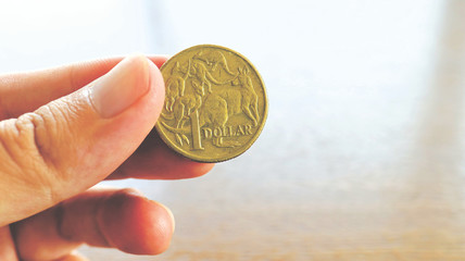 Close the Holding Australian Dollars Coin on Hand and Finger