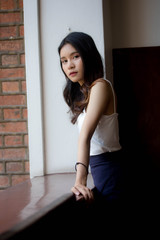 Fototapeta premium Portrait of thai china adult beautiful girl White shirt relax and smile