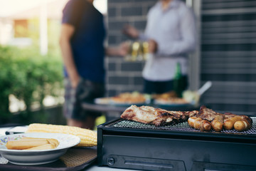 Close up grill with meat and sausage ready for socializing celebrate with friends at outsite home.