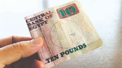 Close up and Holding Egypt Pounds Banknote in Hand