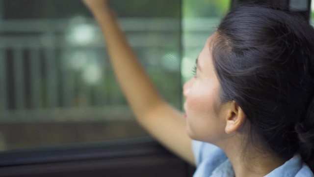 Young woman closing the curtain in car and sleeping during a journey. Shot in 4k resolution