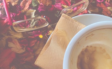 Vintage look with empty cup coffee in beautiful light,red eye grasses and dry flowers feel romatic memorial . stock photo