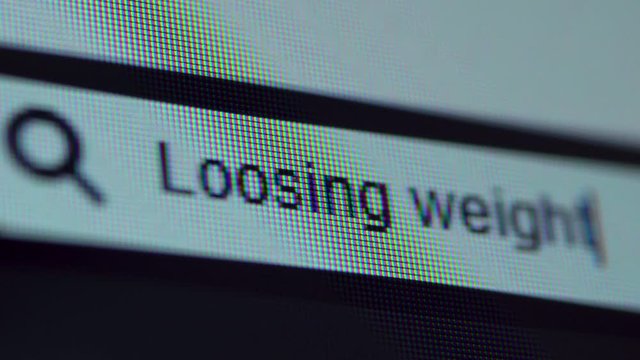 Browser bar with Loosing Weight text typed on the computer screen. Shot in 4k resolution
