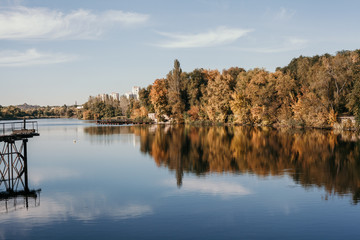 Autumn city landscape with  wide river