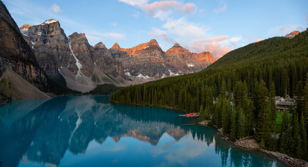 Fototapeta na wymiar Beautiful Panoramic view of an Iconic Famous Place, Moraine Lake, during a vibrant summer sunrise. Located in Banff National Park, Alberta, Canada.