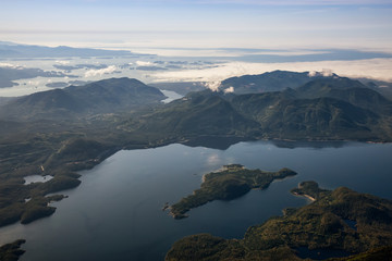 Aerial Landscape View of Kennedy Lake and Pacific Ocean Coast during a sunny summer morning. Taken near Tofino and Ucluelet, Vancouver Island, British Columbia, Canada.