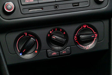 Modern black car interior: climat control view with air conditioning button,.