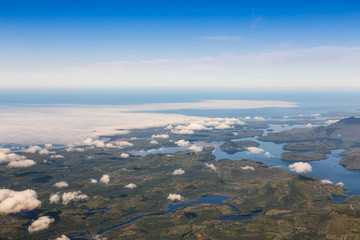 Aerial Landscape View of Beautiful Coastal Mountains on the Pacific Ocean Coast during a sunny summer morning. Taken near Tofino and Ucluelet, Vancouver Island, British Columbia, Canada.