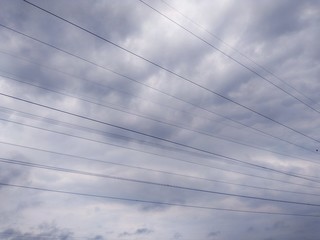 Fototapeta premium high voltage electrical wire isolated on extreme heavy cloudy sky.