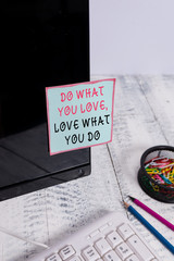 Word writing text Do What You Love Love What You Do. Business photo showcasing Pursue your dreams or passions in life Note paper taped to black computer screen near keyboard and stationary