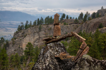 Stack of balancing rocks in nature during a cloudy summer morning. Taken in Skaha Bluffs Provincial Park, Penticton, British Columbia, Canada.