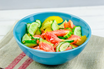 salad with cucumbers and tomatoes on white background